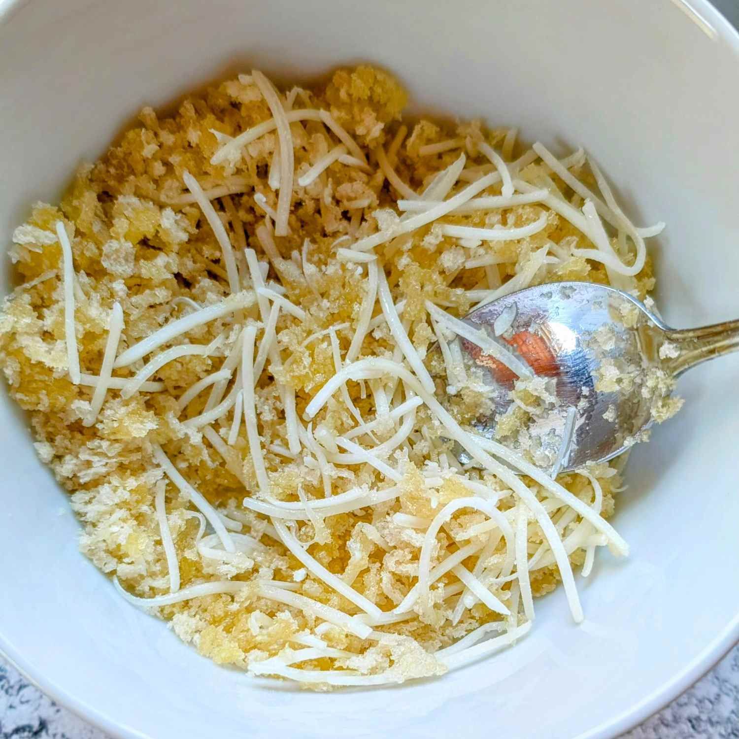 a bowl with low sodium breadcrumb topping with low salt swiss cheese and olive oil