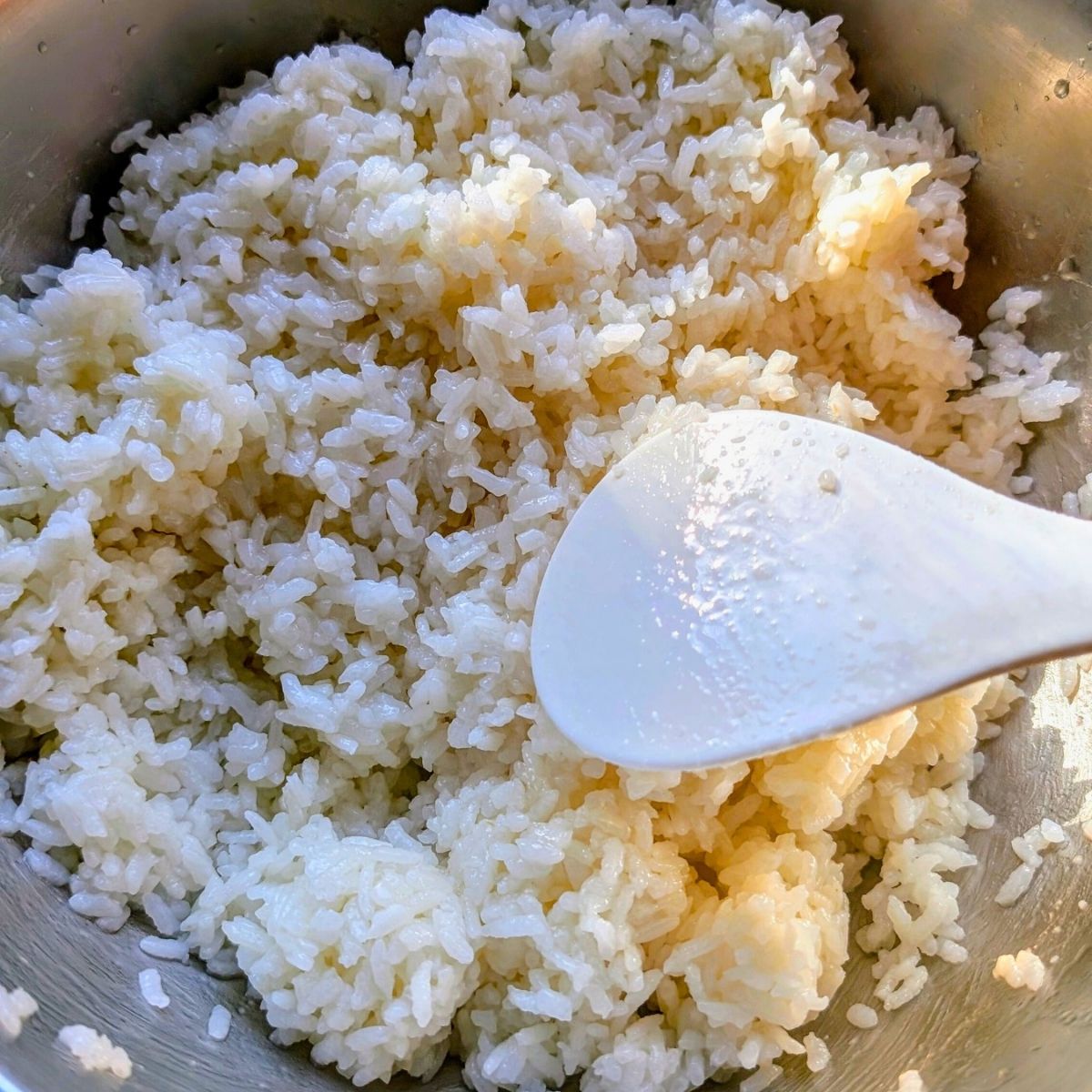 a bowl of sushi rice with rice paddle and low sodium rice recipes