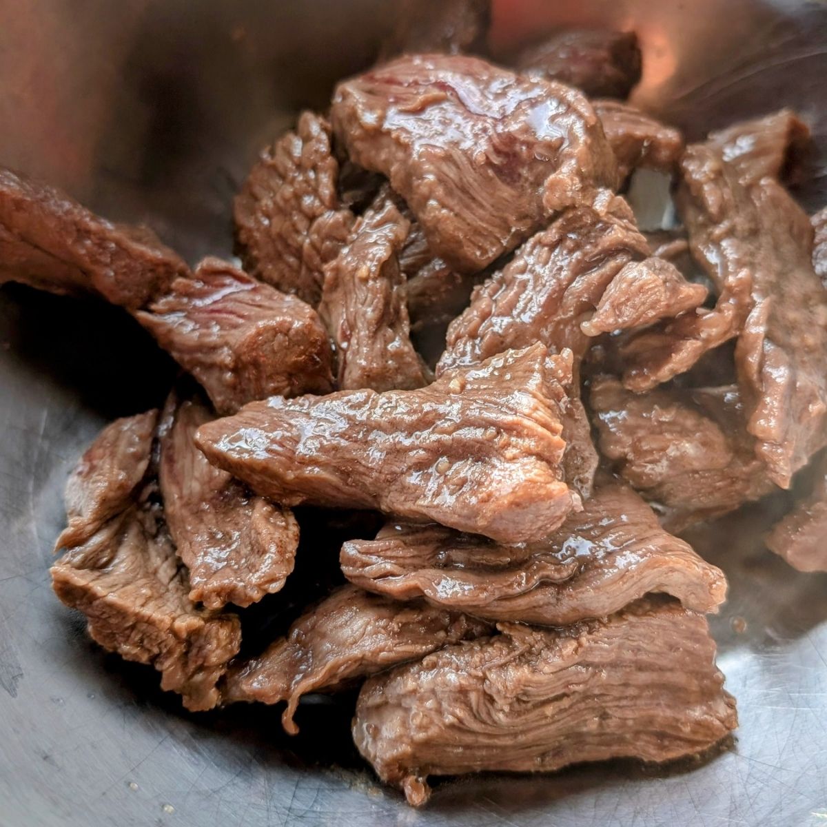 a bowl of teriyaki beef flank steak with no salt added