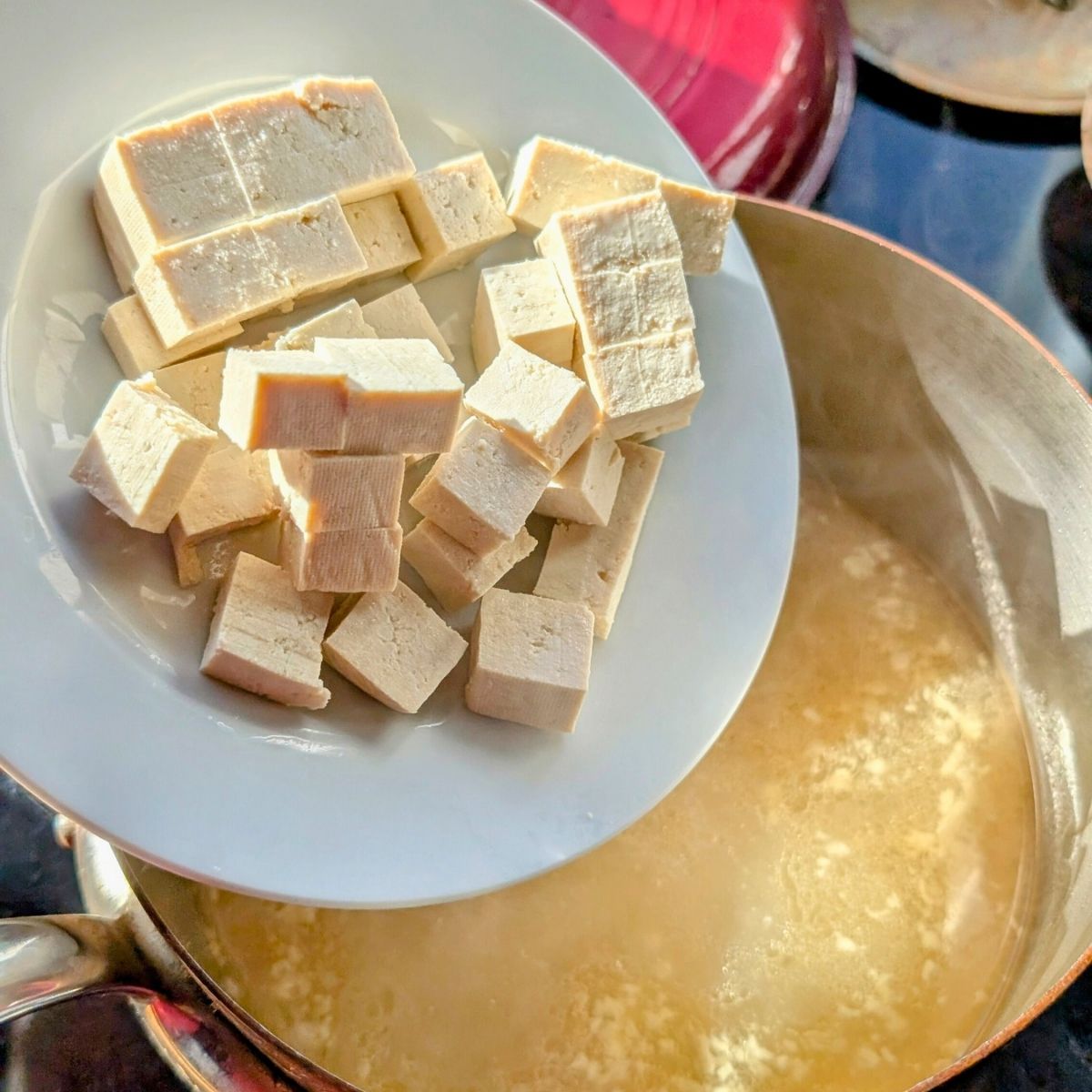 tofu being added to low sodium miso soup for extra protein.