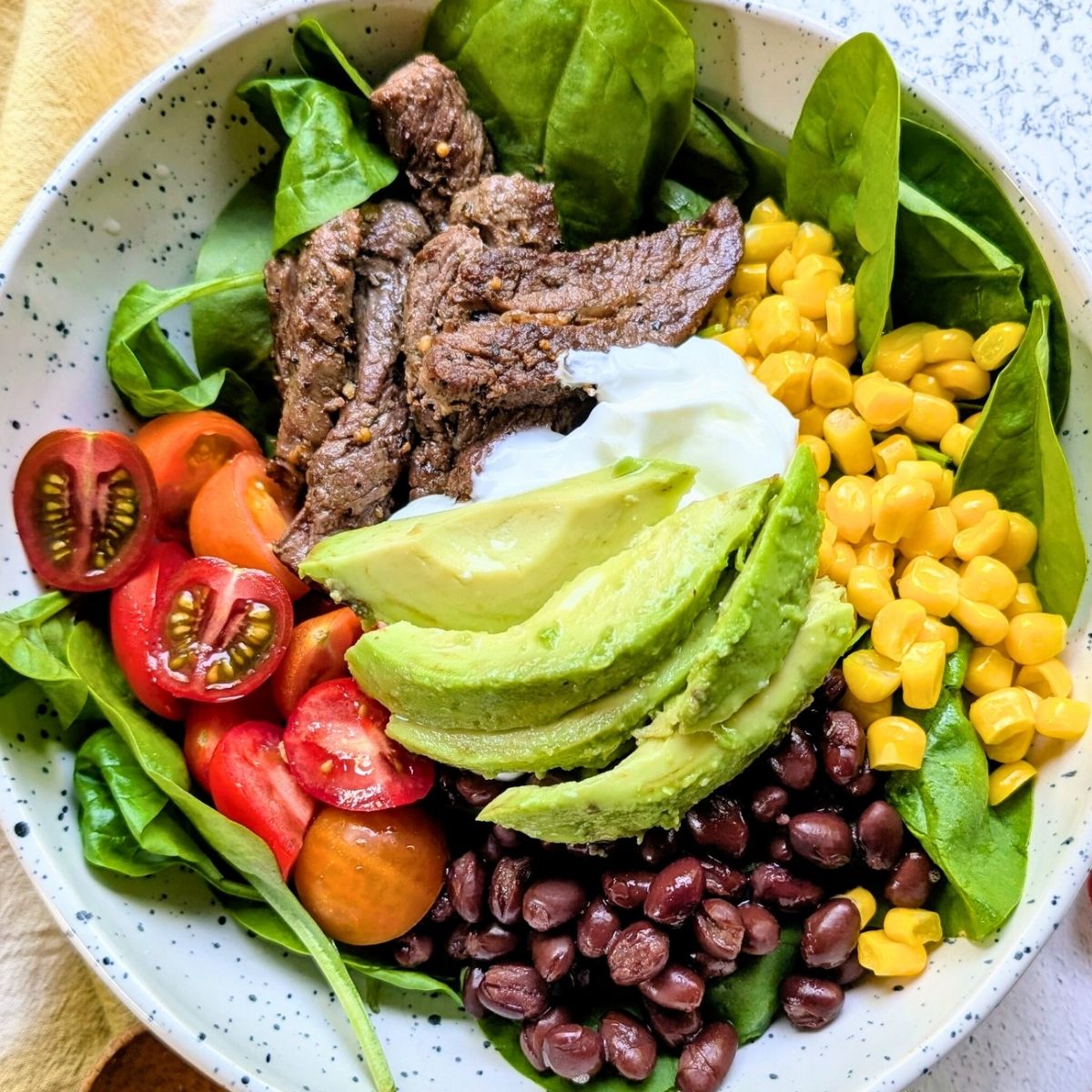 low sodium steak bowls with black beans, corn, lettuce, and avocado.