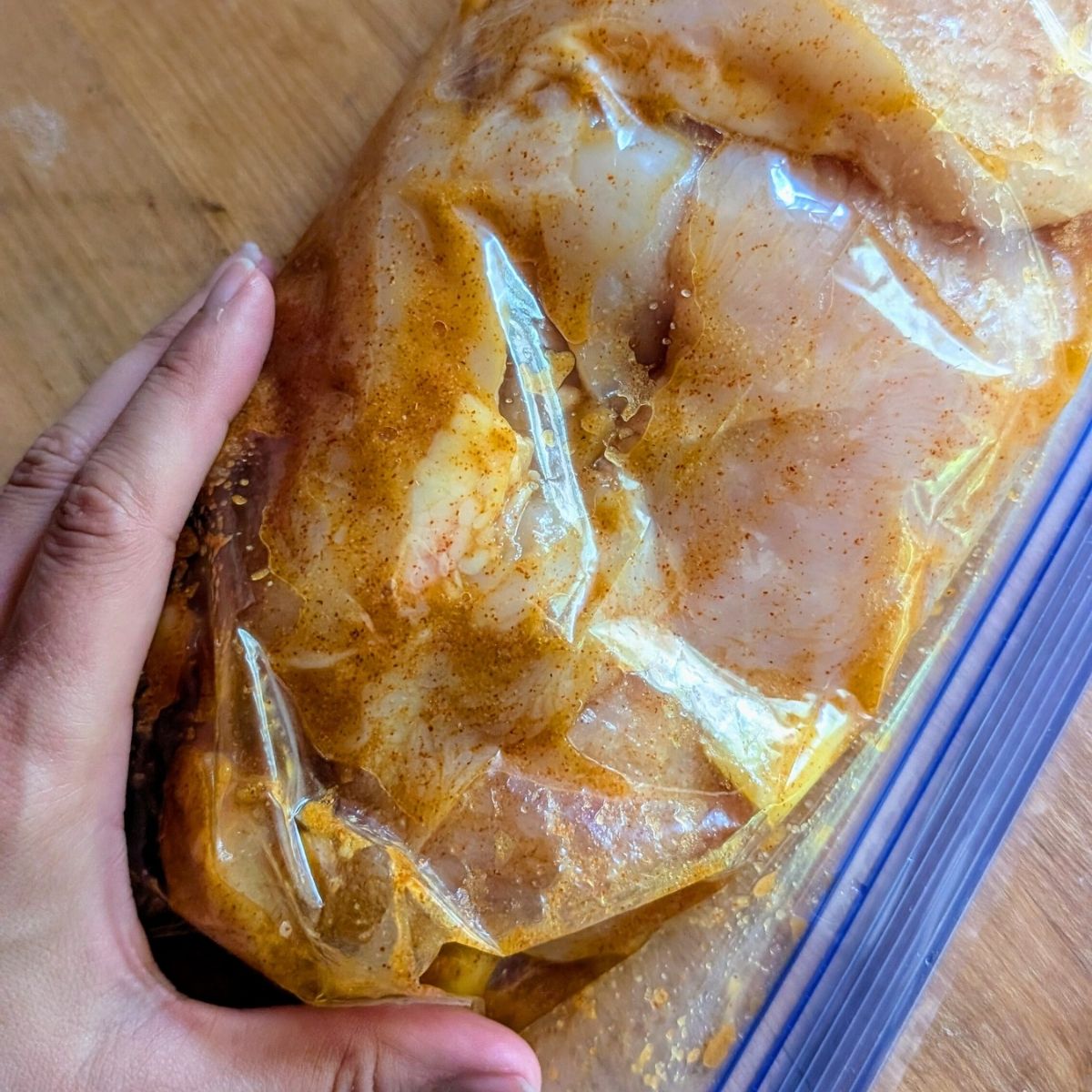 a bag of marinated chicken with mango and lime juice