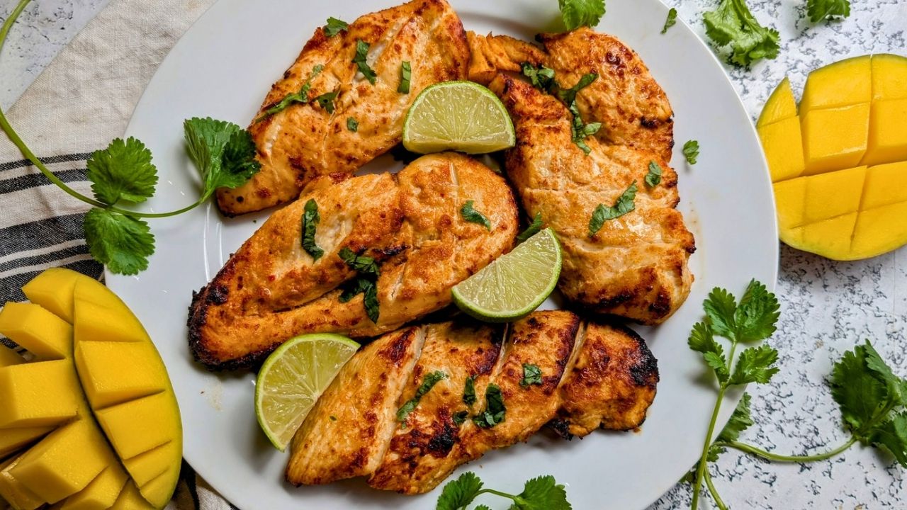 a pan of low salt marinated chicken with mango and lime