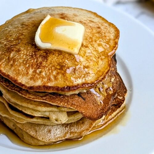 a stack of low sodium pancakes with bananas, cinnamon, and flour with butter and maple syrup on top.