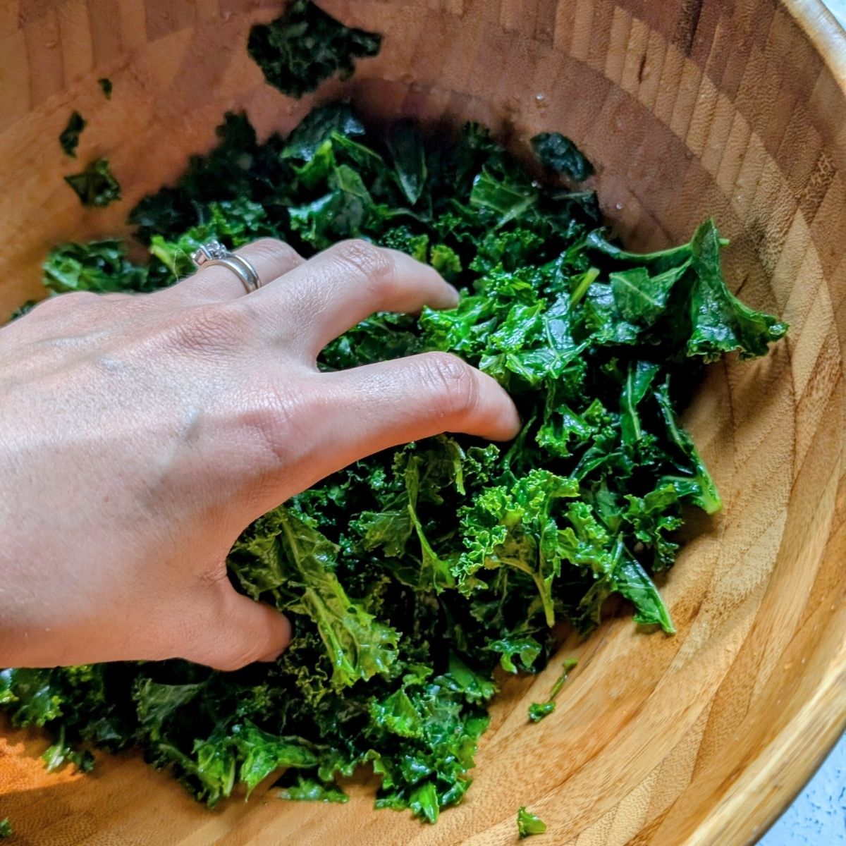 a bowl of kale massaged with olive oil for a low sodium salad idea