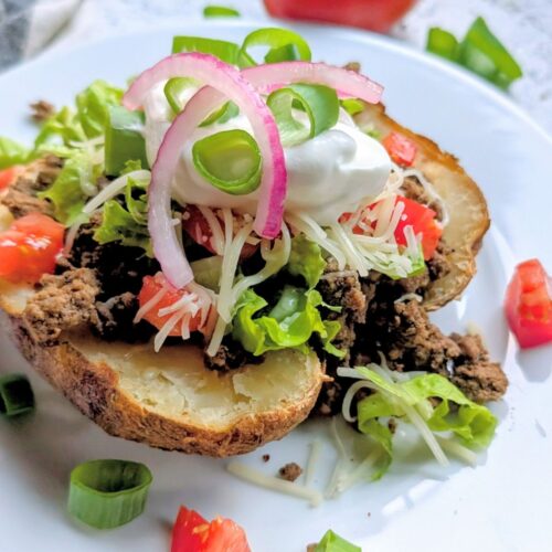a loaded low sodium potato recipe with taco meat, onions, tomatoes, and lettuce.