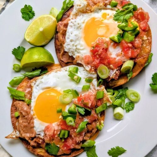 low sodium fried eggs sunny side up on a tortilla with refried beans and salsa and green onions